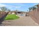 View of the backyard featuring a pool with decorative rock, new grass and fencing at 12493 S 179Th Ln, Goodyear, AZ 85338