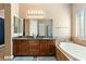 Relaxing bathroom boasts double vanity, soaking tub, and a sunlit window at 12493 S 179Th Ln, Goodyear, AZ 85338
