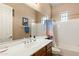Bright bathroom featuring white countertop, a large mirror, and ample natural light through multiple windows at 12493 S 179Th Ln, Goodyear, AZ 85338