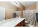 Bathroom featuring a wide vanity, toilet, and a shower/tub with a stylish bamboo patterned curtain at 12493 S 179Th Ln, Goodyear, AZ 85338