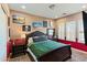 Bedroom showcases a striking headboard, paired with unique decor and inviting natural light at 12493 S 179Th Ln, Goodyear, AZ 85338