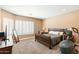Comfortable bedroom with large windows, natural light, and neutral tones at 12493 S 179Th Ln, Goodyear, AZ 85338