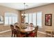 Dining room featuring a wood table with red upholstered chairs and natural light at 12493 S 179Th Ln, Goodyear, AZ 85338