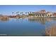 Beautiful community center with a lake, red bridge, manicured lawns and palm trees at 12493 S 179Th Ln, Goodyear, AZ 85338