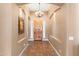 Inviting foyer with wood door, arched entryway and tiled floor at 12493 S 179Th Ln, Goodyear, AZ 85338