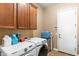 Functional laundry room with modern washer and dryer, complemented by ample cabinet space at 12493 S 179Th Ln, Goodyear, AZ 85338