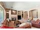 Comfortable living room with a warm fireplace, plush furnishings, and bright light at 12493 S 179Th Ln, Goodyear, AZ 85338