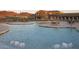 Stunning pool area featuring relaxing water features with surrounding mountain and building views at 12493 S 179Th Ln, Goodyear, AZ 85338
