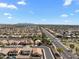 Expansive aerial view of a meticulously planned residential community with stunning mountain views in the distance at 14694 W Mandalay Ln, Surprise, AZ 85379