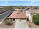 Aerial view of a home showcasing its three-car garage, desert landscaping and neighborhood at 14694 W Mandalay Ln, Surprise, AZ 85379