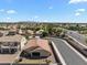 An aerial view of a residential neighborhood with mountain views in the distance at 14694 W Mandalay Ln, Surprise, AZ 85379