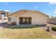 A well maintained backyard with a covered patio and beautiful plants and landscaping at 14694 W Mandalay Ln, Surprise, AZ 85379
