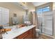 The neutral-toned bathroom features a large vanity and a glass-enclosed shower at 14694 W Mandalay Ln, Surprise, AZ 85379