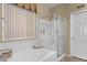 Modern bathroom featuring a soaking tub with tile surround and a separate glass-enclosed shower at 14694 W Mandalay Ln, Surprise, AZ 85379