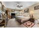 Well-furnished bedroom featuring a ceiling fan, comfortable bedding, and stylish decor at 14694 W Mandalay Ln, Surprise, AZ 85379