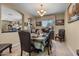 Traditional dining room featuring an elegant chandelier and seating for six at 14694 W Mandalay Ln, Surprise, AZ 85379