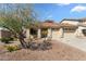 Charming single-story home with a well-manicured front yard and a three-car garage at 14694 W Mandalay Ln, Surprise, AZ 85379