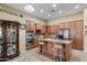 Spacious kitchen featuring wooden cabinets, stainless steel appliances, and a central island with bar stool seating at 14694 W Mandalay Ln, Surprise, AZ 85379