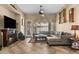 Cozy living room with a fireplace, ceiling fan, and comfortable seating at 14694 W Mandalay Ln, Surprise, AZ 85379