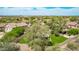 An aerial view of a neighborhood showing homes with tile roofs and desert landscaping at 15691 N 104Th Pl, Scottsdale, AZ 85255