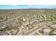 Expansive aerial view of a desert community with mountain views, lush landscaping and winding roads at 15691 N 104Th Pl, Scottsdale, AZ 85255
