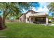 Spacious backyard with lush lawn, patio, and mature trees for outdoor enjoyment and entertaining at 15691 N 104Th Pl, Scottsdale, AZ 85255
