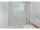 Modern bathroom featuring a glass-enclosed shower over the tub at 15691 N 104Th Pl, Scottsdale, AZ 85255