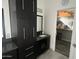 Contemporary bathroom with dark cabinetry and a walk-in closet at 15691 N 104Th Pl, Scottsdale, AZ 85255