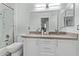 Bathroom featuring double vanity with white cabinets, and glass enclosed shower at 15691 N 104Th Pl, Scottsdale, AZ 85255