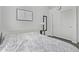 Bedroom with gray wood floors, a mirror, and a closet at 15691 N 104Th Pl, Scottsdale, AZ 85255
