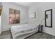 Bedroom with gray floors, a window, and modern decor at 15691 N 104Th Pl, Scottsdale, AZ 85255