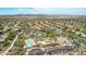 An aerial view of a desert community featuring a pool, tennis courts, playground, and community center at 15691 N 104Th Pl, Scottsdale, AZ 85255