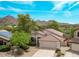 Charming single-story home boasts a tile roof, well-manicured landscaping, and picturesque mountain views at 15691 N 104Th Pl, Scottsdale, AZ 85255