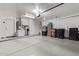 Spacious garage with built-in storage cabinets, epoxy floors, and organized storage solutions at 15691 N 104Th Pl, Scottsdale, AZ 85255