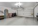 Spacious garage featuring epoxy floors, storage boxes, and a large door at 15691 N 104Th Pl, Scottsdale, AZ 85255