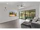 Living room with tile flooring, ceiling fan, and sliding glass door to the backyard at 15691 N 104Th Pl, Scottsdale, AZ 85255