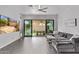 Bright living room with tile flooring, ceiling fan, and sliding glass door to the backyard at 15691 N 104Th Pl, Scottsdale, AZ 85255