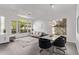 Open-concept living area boasts tile floors, large windows, and a dining area for elegant entertaining at 15691 N 104Th Pl, Scottsdale, AZ 85255