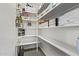 Well-organized pantry featuring white shelving and ample storage space for kitchen essentials at 15691 N 104Th Pl, Scottsdale, AZ 85255