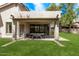 Relaxing covered patio with outdoor dining set overlooking a well-maintained lawn and landscaped backyard at 15691 N 104Th Pl, Scottsdale, AZ 85255