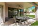 Covered patio features a dining table, ceiling fan, and seamless indoor-outdoor living at 15691 N 104Th Pl, Scottsdale, AZ 85255