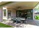 Covered patio featuring a dining table with seating for outdoor entertaining and relaxation at 15691 N 104Th Pl, Scottsdale, AZ 85255