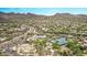 Aerial view of a community pool, basketball court, and tennis courts in a desert landscaped neighborhood at 15691 N 104Th Pl, Scottsdale, AZ 85255