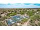 Aerial view of tennis and pickleball courts in a desert landscaped community, with mountain views at 15691 N 104Th Pl, Scottsdale, AZ 85255