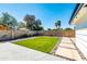 Well-maintained backyard with artificial turf, a paved walkway, and tasteful landscaping at 1607 E Gable Ave, Mesa, AZ 85204