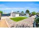 Stunning backyard with pool, green space, rock garden, lounge chairs, and a covered patio area perfect for entertaining at 1607 E Gable Ave, Mesa, AZ 85204