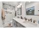 Updated bathroom with double sinks, modern fixtures, and an all-glass shower at 1607 E Gable Ave, Mesa, AZ 85204