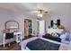 Spacious bedroom features two beds, a walk-in closet, desk and dark hardwood floors at 1607 E Gable Ave, Mesa, AZ 85204