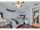 Cozy bedroom with dark wood floors, decorative wall accents, and a comfortable bed setting at 1607 E Gable Ave, Mesa, AZ 85204