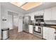 Modern kitchen features stainless appliances, white cabinets, and tile flooring at 1607 E Gable Ave, Mesa, AZ 85204